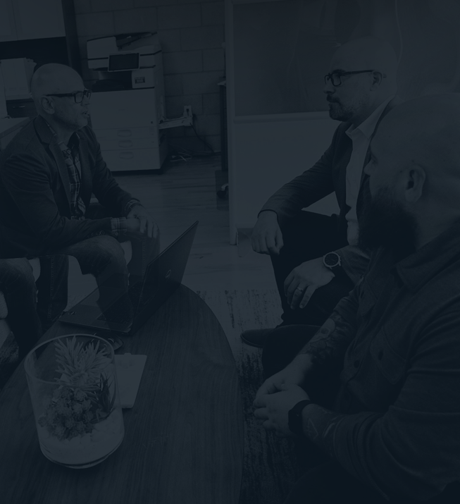 SparkBlue team talking around a table