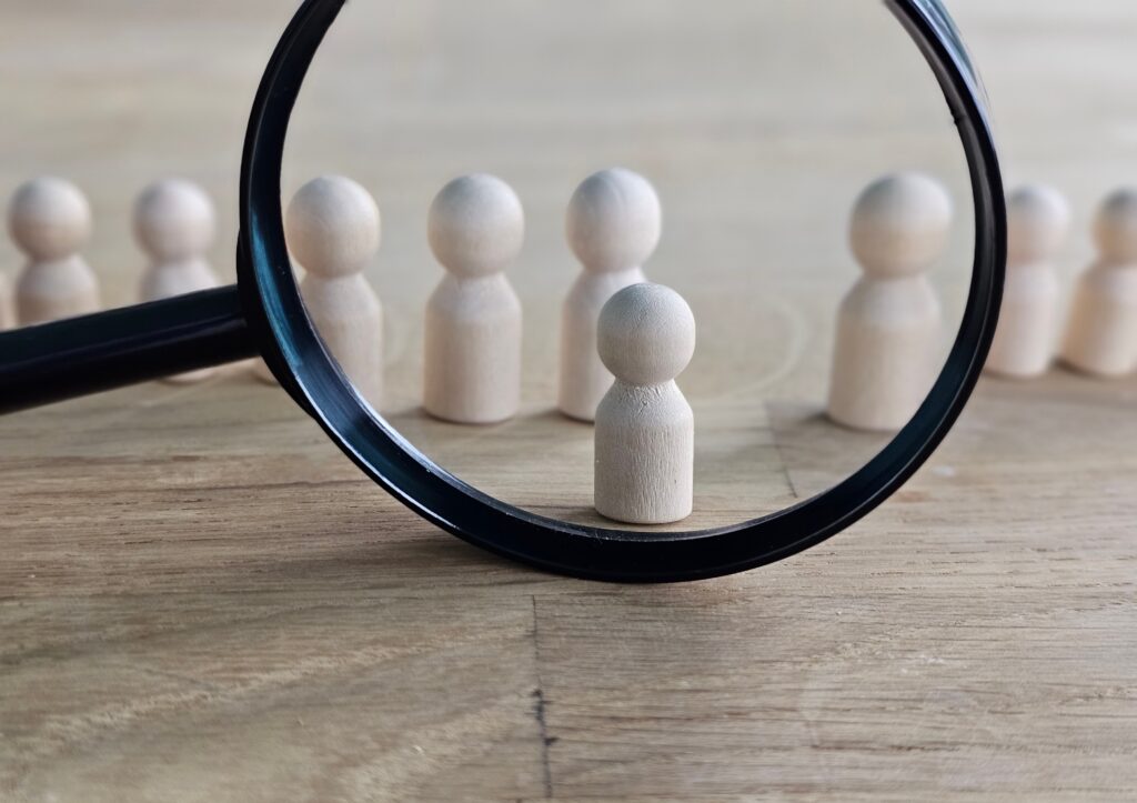 Magnifying glass with wooden people