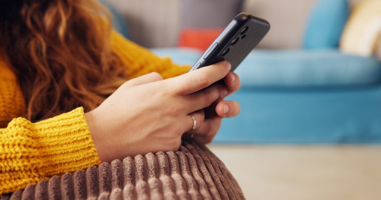 Woman typing on her phone